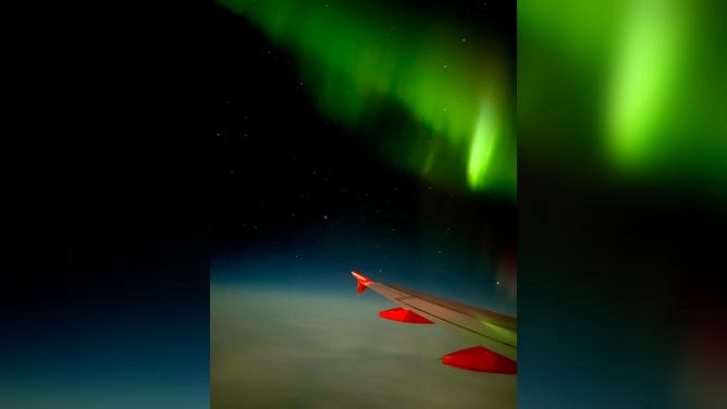 Northern Lights over the wing of easyJet flight from Reykjavik, Iceland to Manchester, U.K. February 27, 2023.