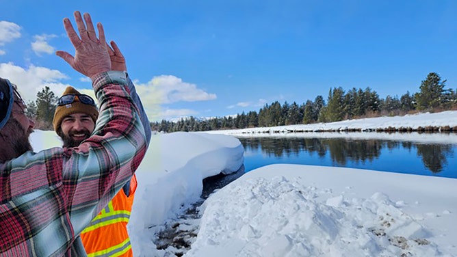 Mike Mease and Joey Morin celebrate completion of bison snow corridor on the Madison River