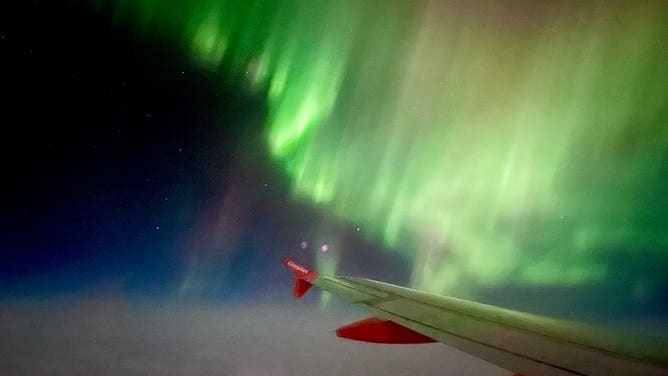 Northern Lights over the wing of easyJet flight from Reykjavik, Iceland to Manchester, U.K. February 27, 2023.