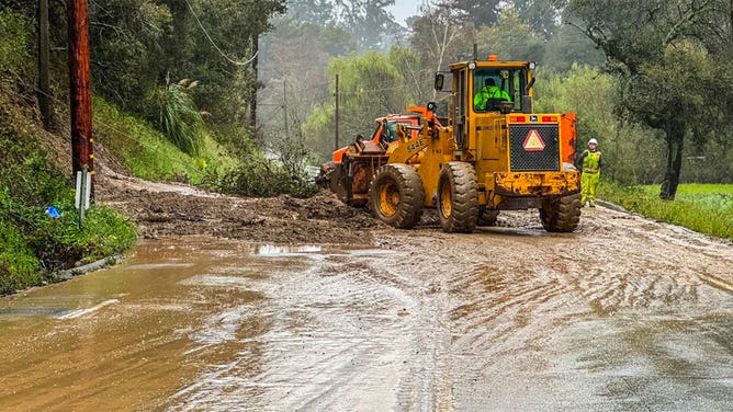 Crews work to clean up a mudslide in Santa Cruz County, California, during an atmospheric river March 10, 2023.