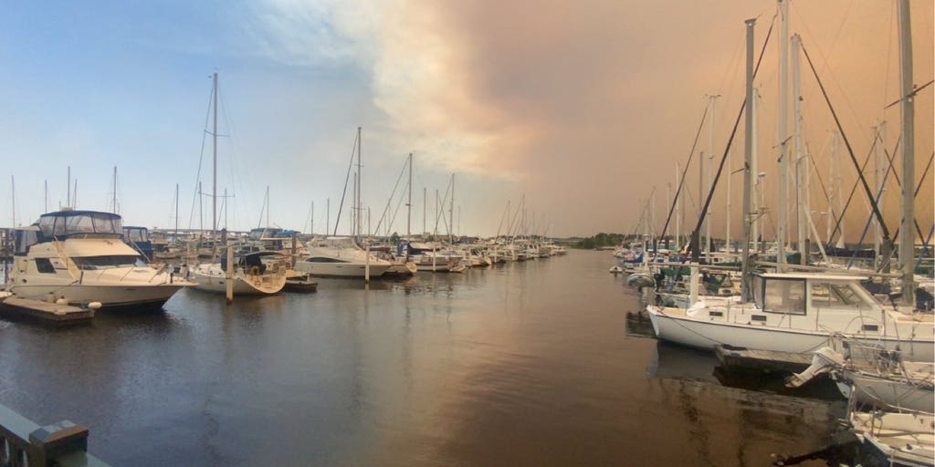 Massive North Carolina forest fire sends clouds of smoke and ash over towns