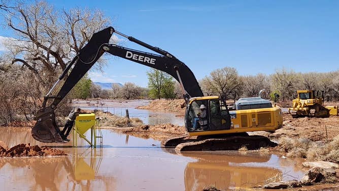 Emergency officials try to tame the floodwaters.