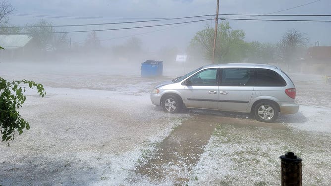 Fog rises from the ground covered by hailstones in Ballinger, Texas, on April 22, 2023.