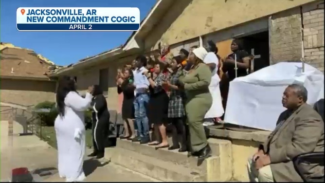 A choir sings in front of New Commandment Church of God in Christ in Jacksonville, Arkansas. April 2023.