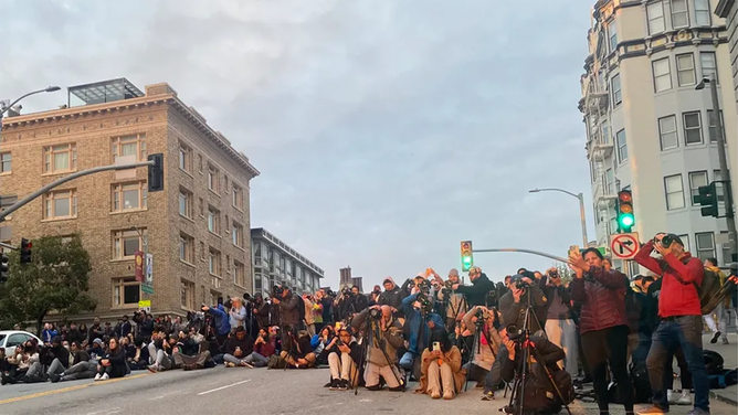 The intersection was totally blocked by the crowd at Gough and California Streets in San Francisco April 8, 2023. 