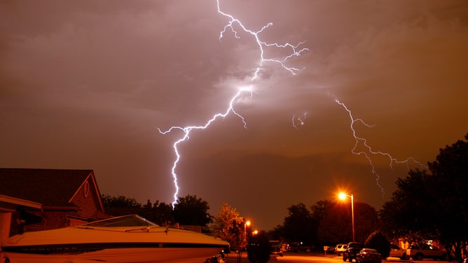FILE - Lightning associated with severe thunderstorms over northern Fort Worth, Texas, June 20, 2011.