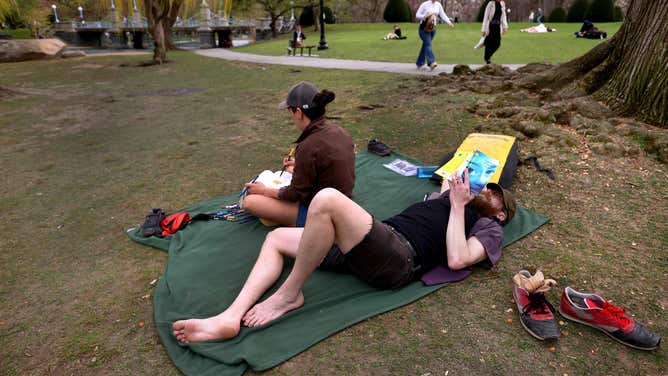People take advantage of the warm weather in Boston Public Garden. April 12, 2023.