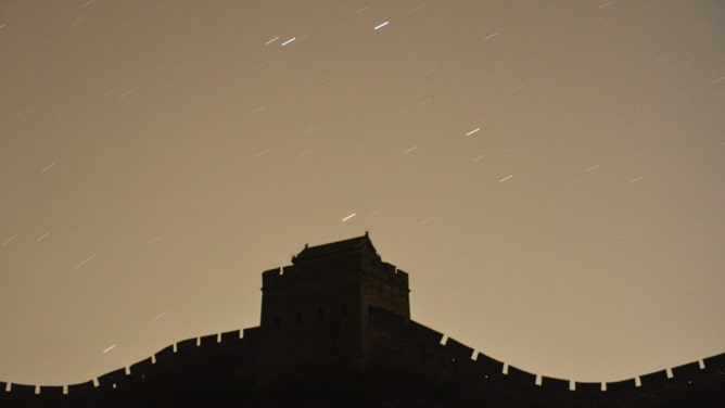 The annual April Lyrids meteor showers illuminate the night sky over the Jinshanling Great Wall on April 22, 2022 in Luanping County, Chengdu City, Hebei Province of China.