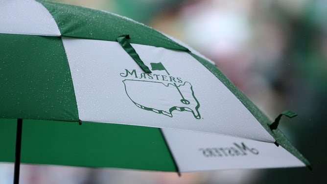 A patron holds a Masters umbrella in the rain during the second round of the 2013 Masters Tournament at Augusta National Golf Club on April 12, 2013 in Augusta, Georgia.