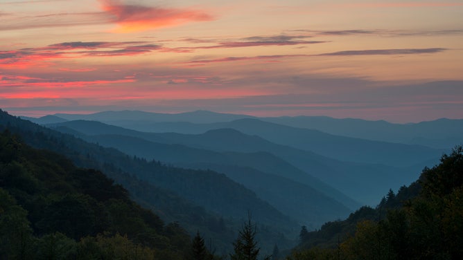 FILE - View from the Oconaluftee Overlook of the Oconaluftee Valley with pink clouds at sunrise in the Great Smoky Mountains National Park in North Carolina, USA.