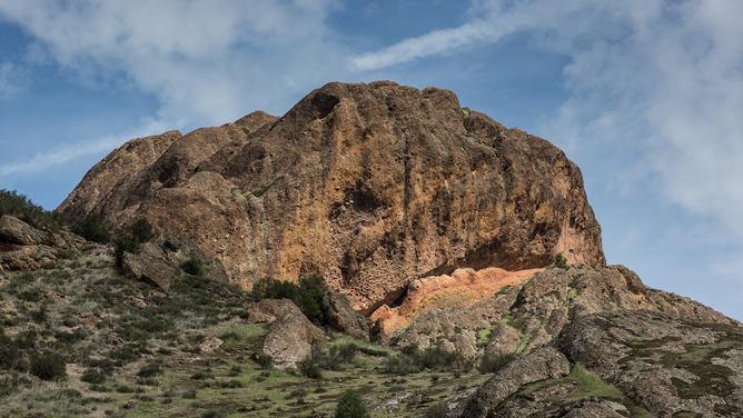 FILE - Unusual rock formations and oak and pine trees dot the western edge of Pinnacles National Park as viewed on April 12, 2018, near Soledad, California. Pinnacles National Park is a designated wilderness protecting a mountainous area located east of the Salinas Valley in Central California, about 5 miles east of Soledad.