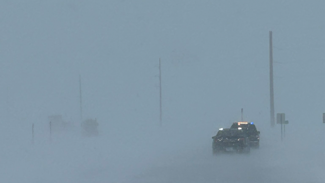 Wind-driven snow is seen on a highway in South Dakota during a blizzard on April 4, 2023.
