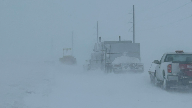 Cars and trucks are seen suck on the side of a road in South Dakota during a blizzard on April 4, 2023.