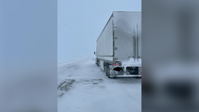 A photo showing a tractor-trailer stuck in snow in South Dakota. The South Dakota Highway Patrol says road and visibility conditions are rapidly deteriorating in the northeastern corner of the state.