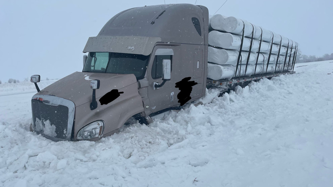 A photo showing a tractor-trailer stuck in snow near the New Effington exit on Interstate 29 in South Dakota on April 4, 2023.