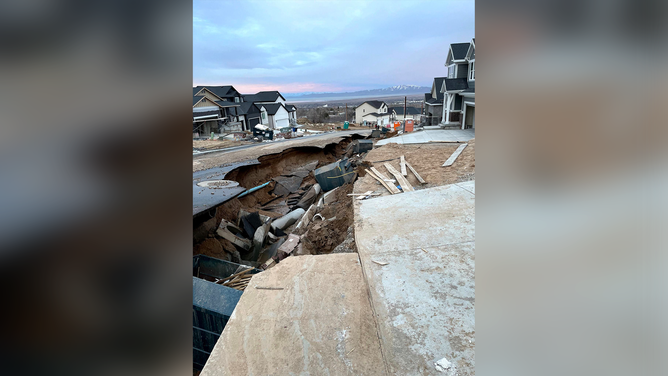 A section of road was washed away in the city of Kaysville, Utah, after flooding on Wednesday.