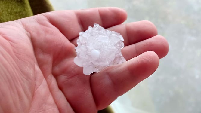 A person holds a hailstone that fell southeast of Pittsburg, Kansas, April 15, 2023.