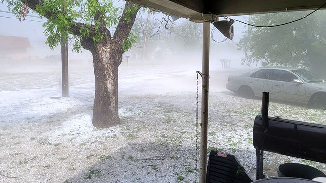 Fog rises from the ground covered by hailstones in Ballinger, Texas, on April 22, 2023.