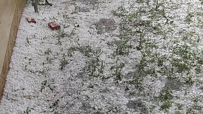 Hail stones cover the ground in Ballinger, Texas, on April 22, 2023.