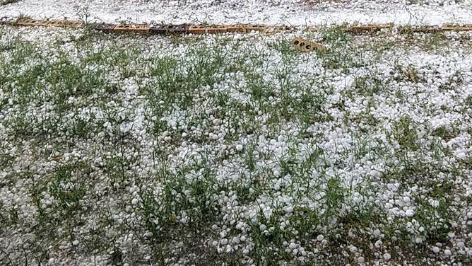 Hail stones cover the ground in Ballinger, Texas, on April 22, 2023.