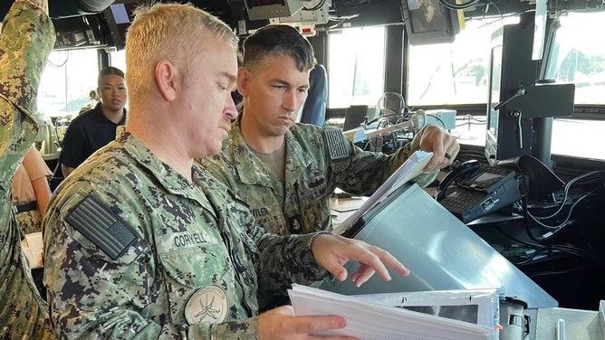 PEARL HARBOR, Hawaii (Nov. 21, 2022) - Sailors from Joint Typhoon Warning Center (JTWC) conducted fleet liaison observation training with Quatermasters (QM) and Aerographer’s Mates (AG) onboard the USS DANIEL K. INOUYE (DDG 118). AG2(IW) Dylan Howard and AG2(IW) Beautyful Brown observed how QMs conduct their observations. QM2 Kristen Fauber led the charge for the crew and was highly motivated to help improve her skills along with crewmembers LT Juan Cardona, QMC(AW) Leslie Butler, QM2(SW) Devron Ford, QM2 Levi Mcgowankizziar, QM3 Elijah Deleon, and QMSN Harrison Burgess. Fauber and the other QMs were querying Chief Warrant Officer 3 Justin Coryell on how to use the Computer Training wheel CP-264/U. JTWC’s lead training officer, Dr. Owen Shieh helped explain the paramount reasons for the quality of their observations for the Fleet Numerical Meteorology and Oceanography Center modeling, in data sparse areas and JTWC forecasts. Those present were able to gain a greater understanding on how to take sea height observations, swell directions, and a greater familiarization on filling out the synoptic hour observations. The training conducted was quintessential in bridging the gap between QMs and AGs on the Hawaiian waterfront since the start of COVID. This was a long-standing tradition for the JTWC Sailors prior to COVID, and looks to be blossoming anew. (U.S. Navy photo courtesy of Joint Typhoon Warning Center Public Affairs)