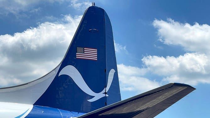 The NOAA logo is seen painted on the tail of a WP-3D Orion airplane used by the agency's Hurricane Hunters during a stop in Houston on May 1, 2023.