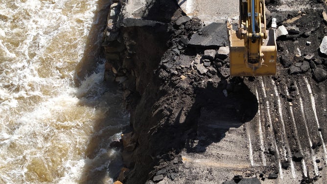 A bulldozer tends to a crumbling SR-39 in Utah. May 11, 2023.