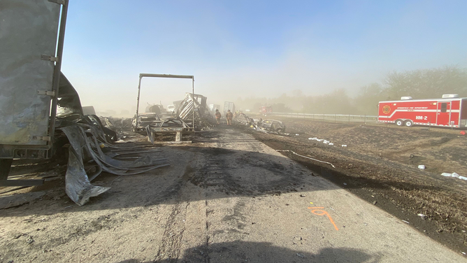 First responders are seen looking through crash debris on I-55 in Illinois on Monday, May 1, 2023.