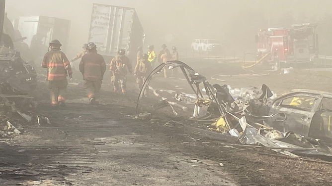 Smoke and dust fill the air after a massive pileup during a dust storm on I-55 in Illinois on Monday, May 1, 2023.