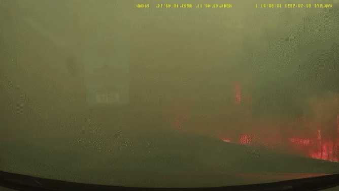 A dramatic image showing a man trying to escape a raging wildfire in Nova Scotia, Canada, on May 28, 2023.