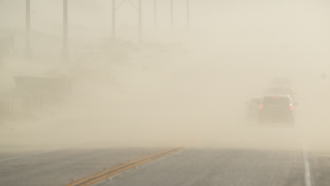 FILE - A dust storm moves across North Indian Canyon Road on December 30, 2022 north of Palm Springs, California.