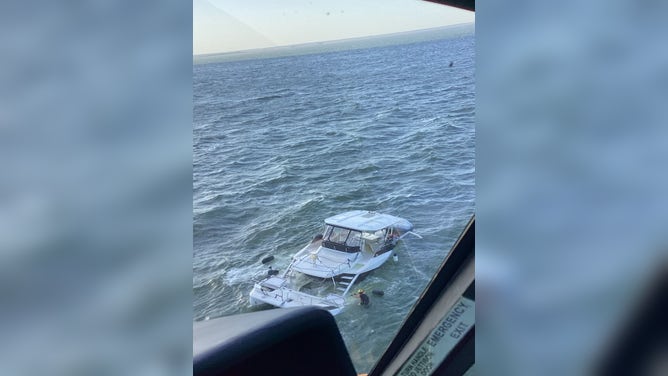 Watch: 2 boaters, dog plucked from catamaran by Coast Guard as it sank off Georgia coast