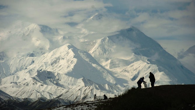 FILE - Mount McKinley forms the backdrop for photographers in Denali National Park in 2006. (Photo by Bob Hallinen/Anchorage Daily News/Tribune News Service via Getty Images)