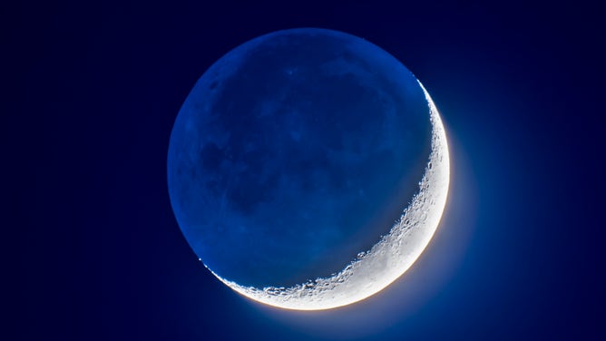 FILE - The 4-day-old waxing crescent Moon on April 8, 2019 in a blend of short and long exposures to bring out the faint Earthshine on the dark side of the Moon and deep blue twilight sky while retaining details in the bright sunlit crescent.