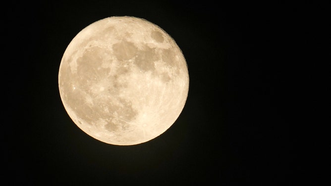 June’s full moon, the strawberry supermoon rises above Houston Tuesday, June 14, 2022. 