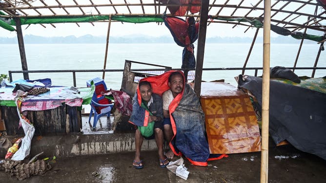 Local residents take shelter in Kyauktaw in Myanmar's Rakhine state on May 14, 2023, as Cyclone Mocha's crashes ashore. Cyclone Mocha crashed ashore in Myanmar and southeastern Bangladesh on May 14, 2023, uprooting trees, scattering flimsy homes in Rohingya displacement camps and bringing a storm surge into low-lying areas.