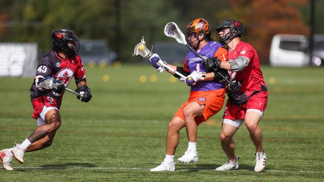 Tehoka Nanticoke of Haudensaunne and Graeme Hossack and Latrell Harris of Canada in action during the game between Canada (15) and Haudensaunne (14) at the Lacrosse International Super Sixes Tournament on October 24, 2021 in Sparks, Maryland.