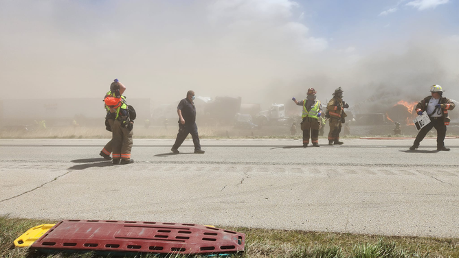 First responders are seen racing toward the scene of a massive crash after a dust storm on I-55 in Illinois on May 1, 2023.