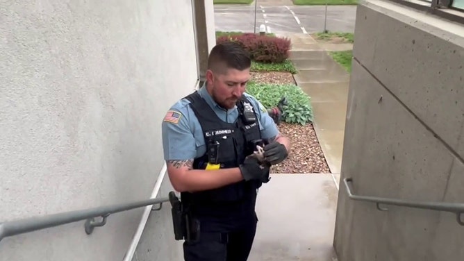 Kansas cop saves baby opossum seeking shelter from the rain