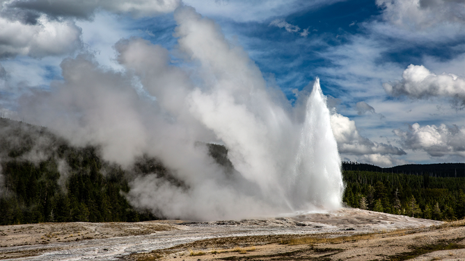 FILE - The iconic Old Faithful Geyser springs to life (every 90 minutes) in Yellowstone National Park's Upper Geyser Basin on September 18, 2022, in Yellowstone National Park, Wyoming. Sitting atop an active volcanic caldera, Yellowstone, America's first National Park, is home to more geological hydrothermal features (geysers, mud pots, hot springs, fumaroles) than are found in the rest of the world combined.