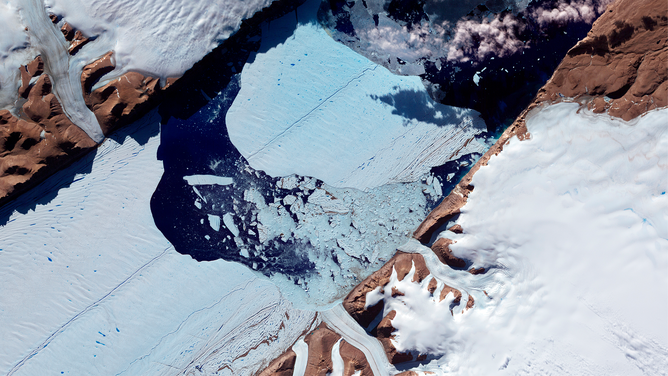FILE - In July 2012, a massive ice island broke free of the Petermann Glacier in northwestern Greenland. On July 16, the giant iceberg could be seen drifting down the fjord, away from the floating ice tongue from which it calved.