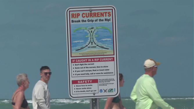 A sign showing the danger of rip currents in Florida.