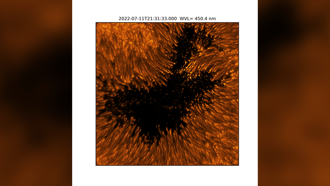 This image reveals the fine structures of a sunspot in the photosphere. Within the dark, central area of the sunspot’s umbra, small-scale bright dots, known as umbral dots, are seen. The elongated structures surrounding the umbra are visible as bright-headed strands known as penumbral filaments. Umbra: Dark, central region of a sunspot where the magnetic field is strongest. Penumbra: The brighter, surrounding region of a sunspot’s umbra characterized by bright filamentary structures.