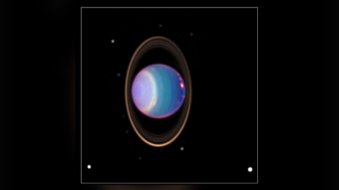 Uranus is surrounded by its four major rings and 10 of its 27 known moons in this color-added view that uses data taken by the Hubble Space Telescope in 1998. A study featuring new modeling shows that four of Uranus’ large moons likely contain internal oceans