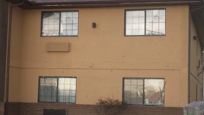 The side of a building is seen severely damaged by hail in Grinnell, Iowa, on Sunday, May 7, 2023.
