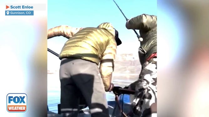 A Lake trout that was caught in a Colorado reservoir was so big that both Scott Enloe and his son, Hunter, needed to work together to pull it into the boat.