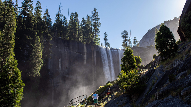 FILE - Visitors hike the Mist Trail toward Vernal Fall in the Yosemite National Park, California on July 03, 2020.