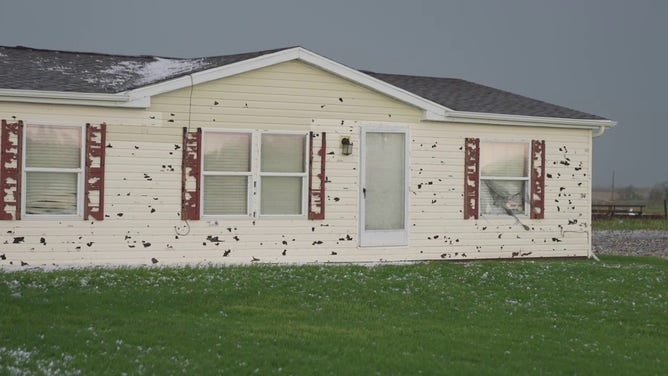 Siding on a home is seen severely damaged by hail in Grinnell, Iowa, on Sunday, May 7, 2023.