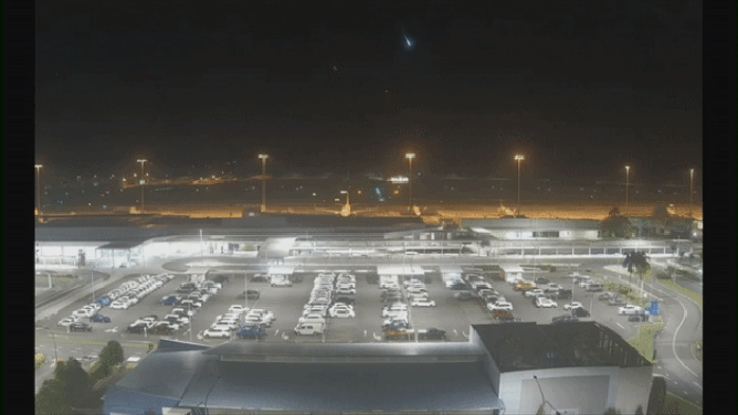 Video captured at an Australian airport, shows a meteor flashing a bright green as it fell to Earth.