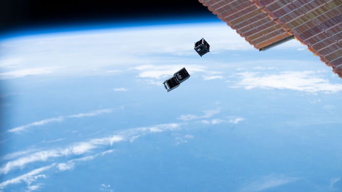FILE - CubeSats above the Earth.
